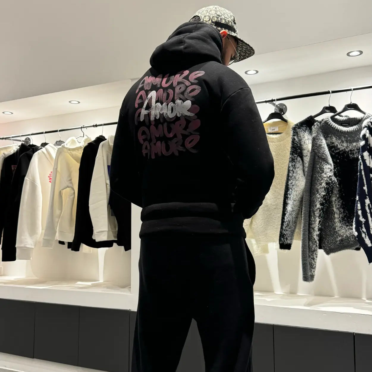 Focus sur le dos du modèle révélant l'accumulation des prints Amore au style rouge à lèvres.