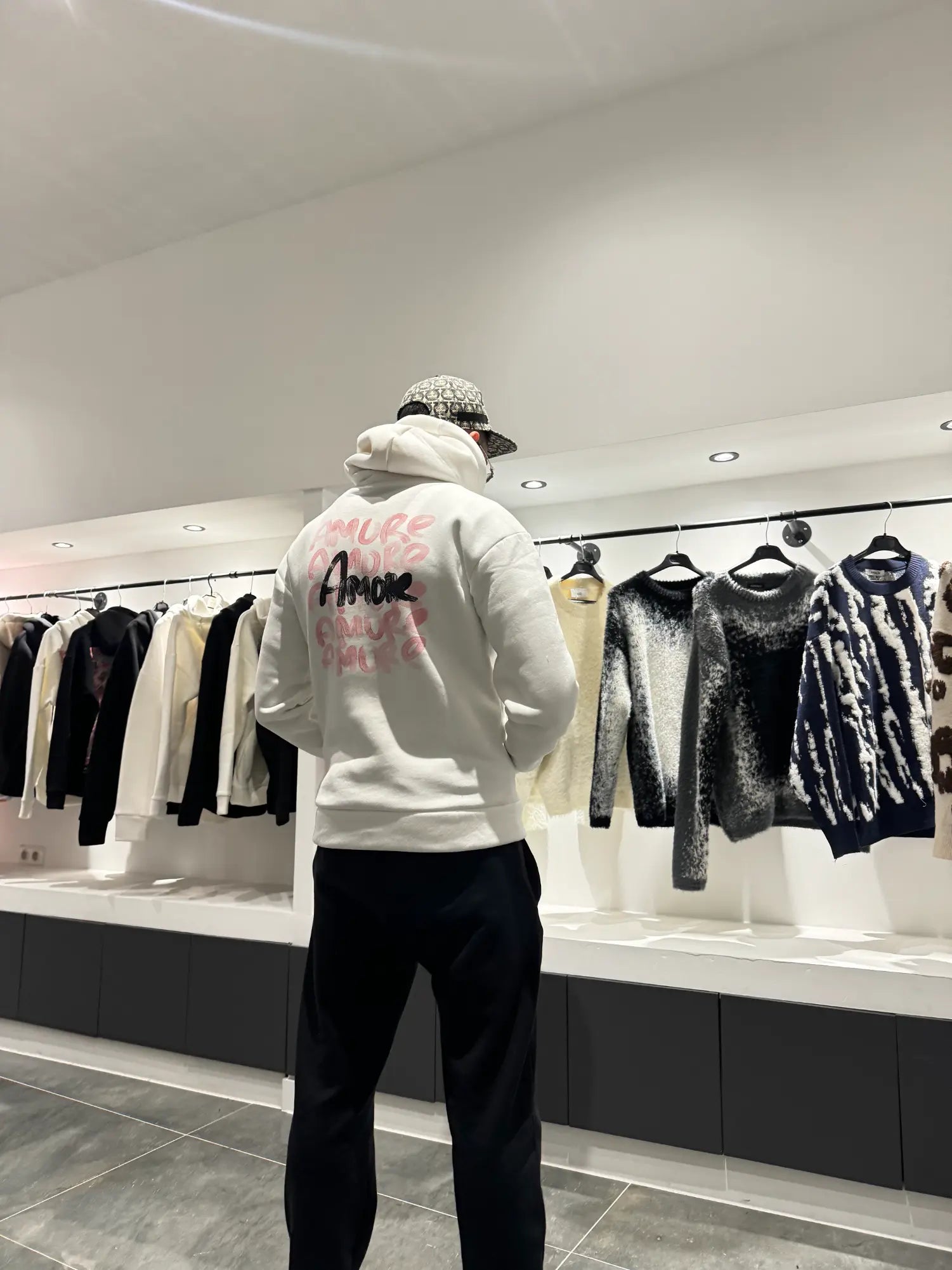 Focus sur les écritures amore au style rouge à lèvres au dos du pull blanc ADJ.