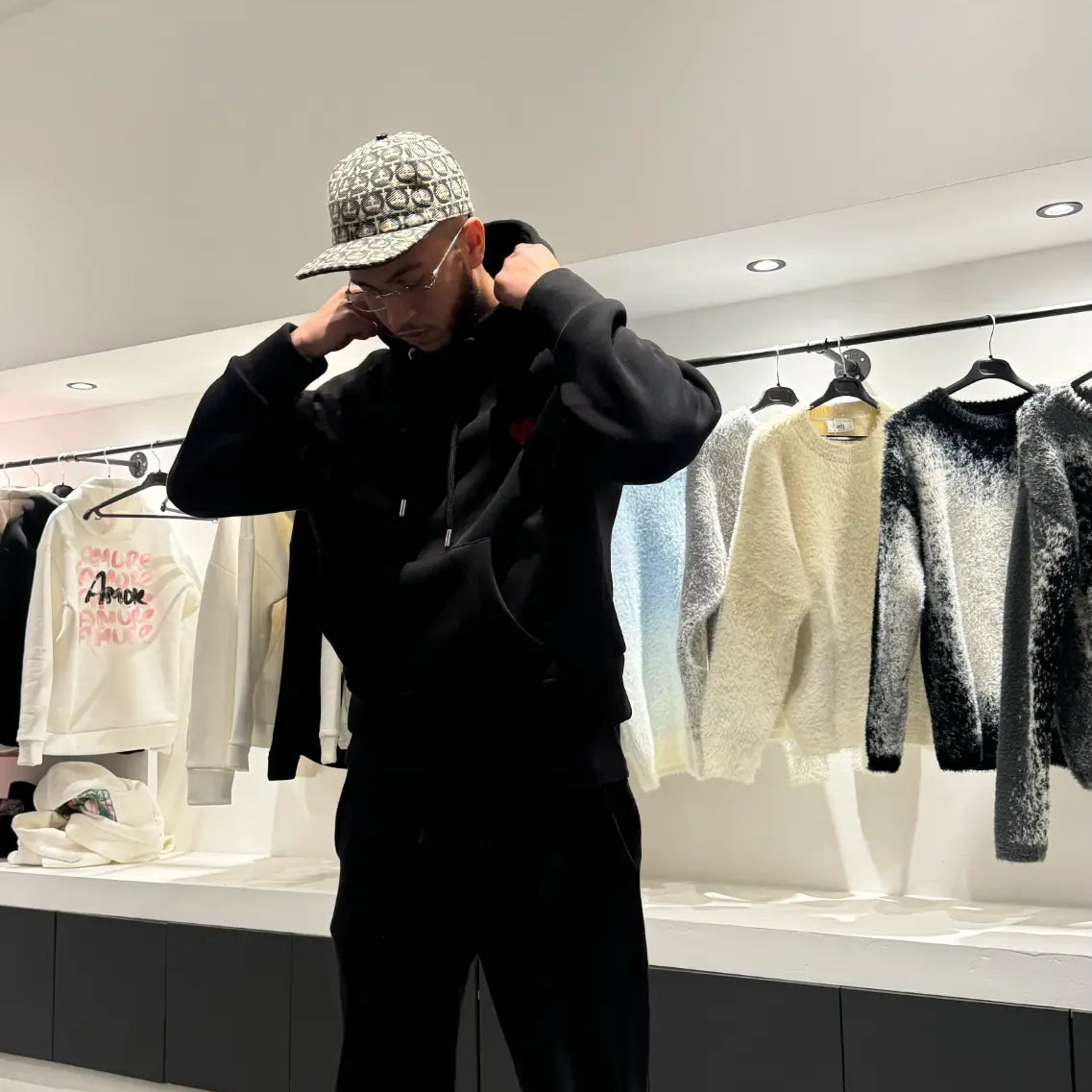 Silhouette complète montrant le tombé large et le style décontracté du pull noir ADJ.
